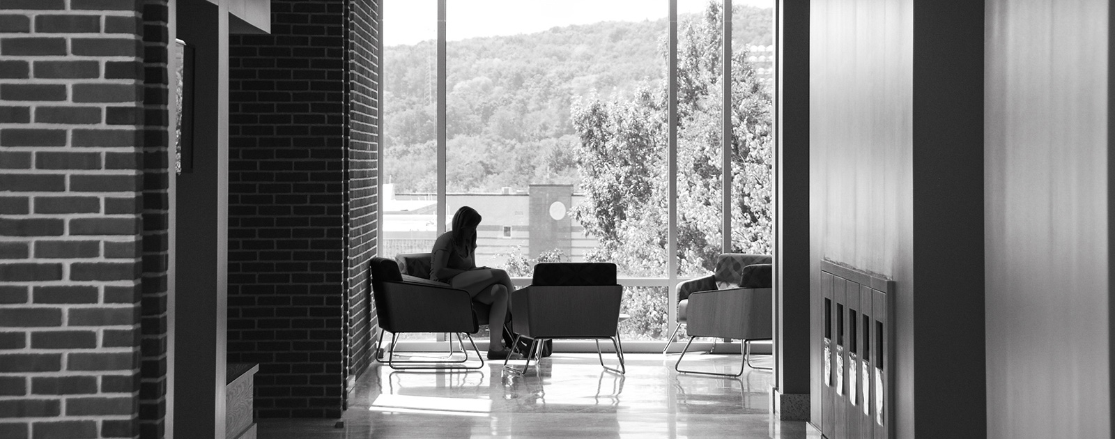 Student sitting by window on campus